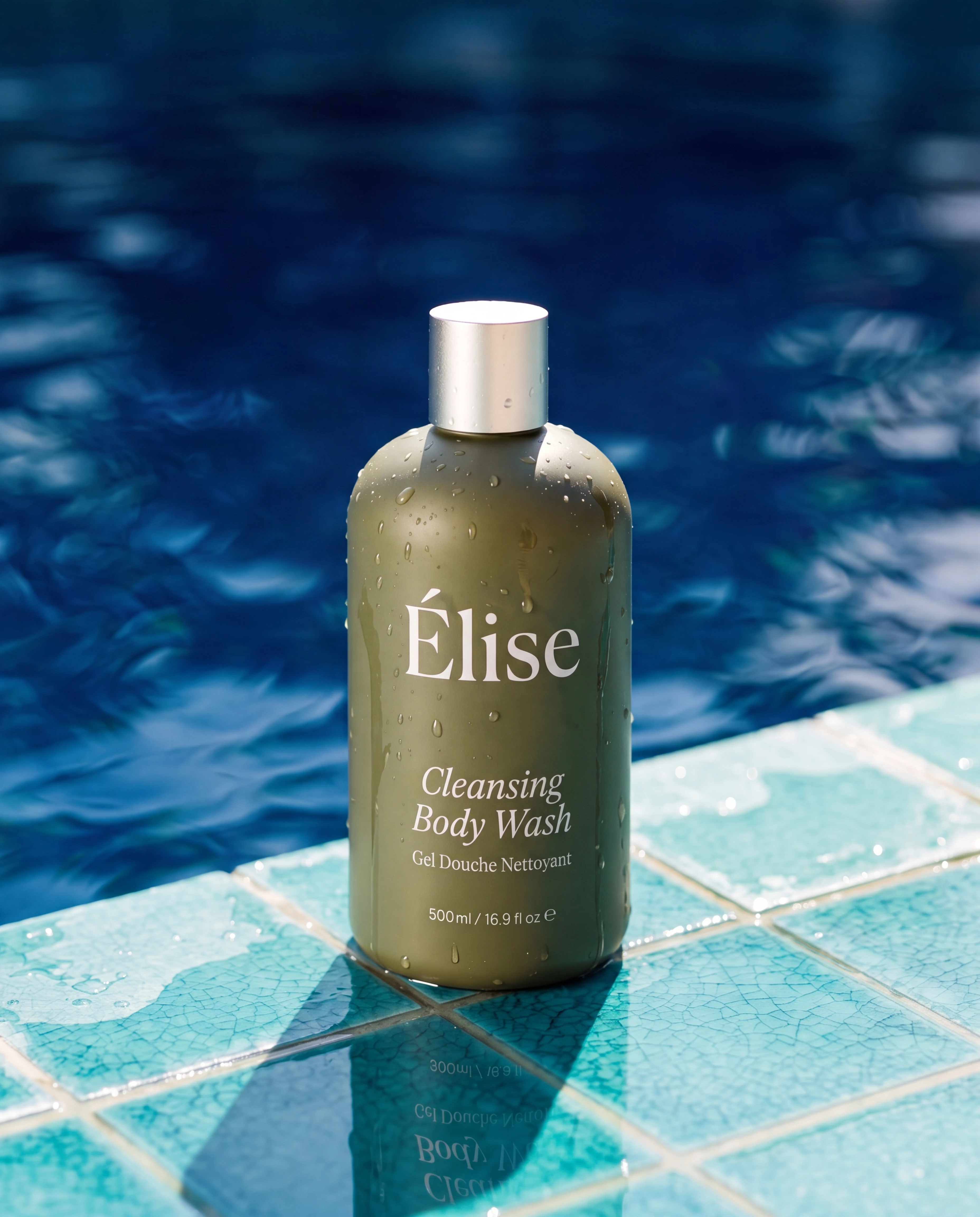 A wet Elise body-wash bottle standing on turquoise pool tile with a physically correct reflection