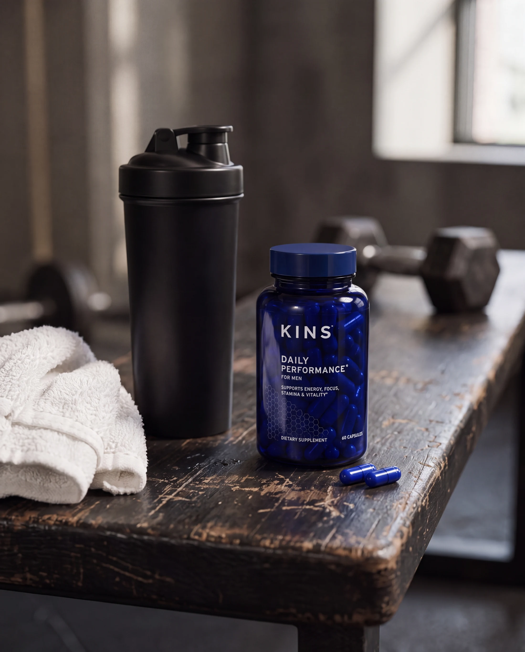 KINS supplement with unbranded training equipment on a worn gym bench