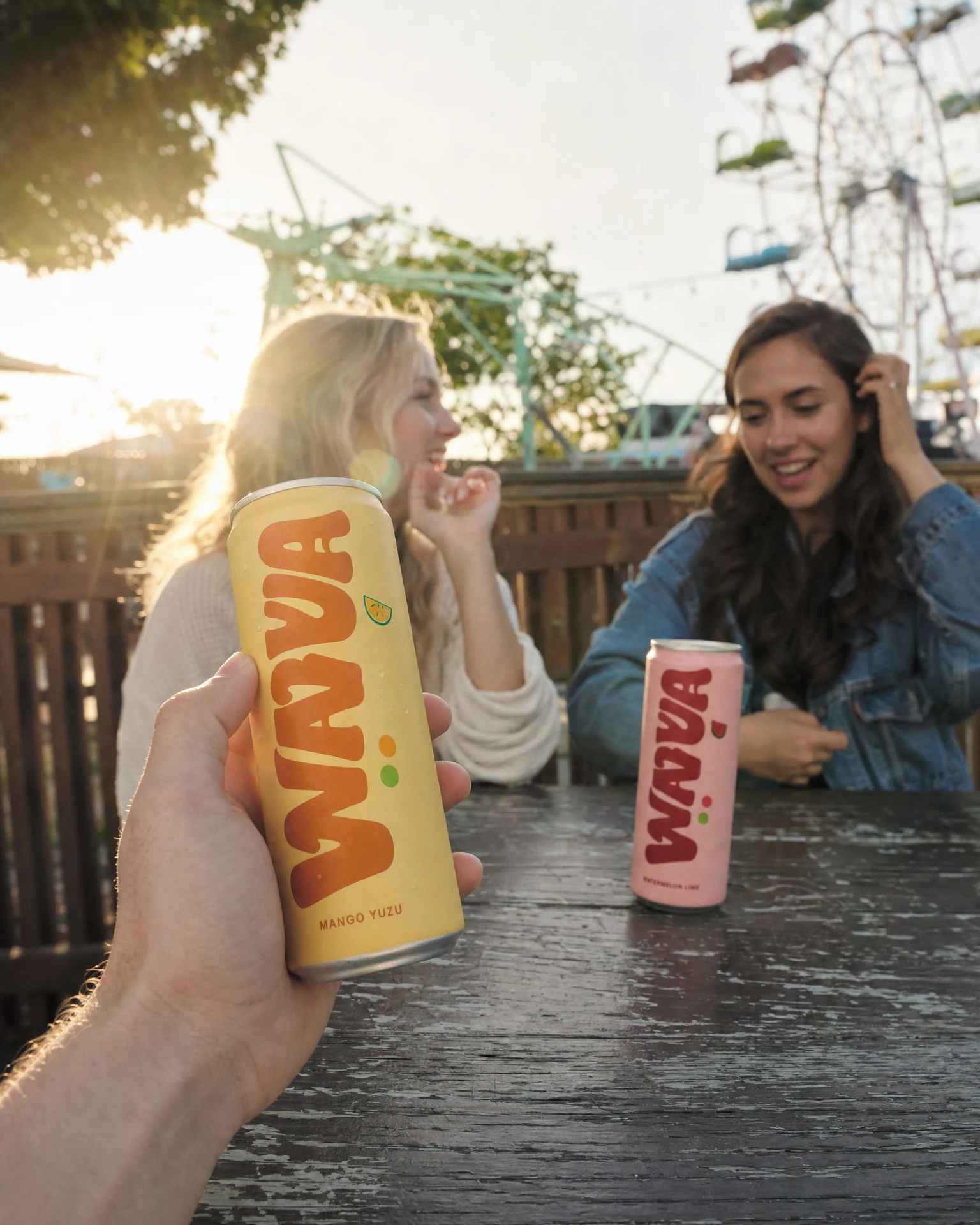 Wavva Mango Yuzu energy drink held naturally during an amusement-park outing