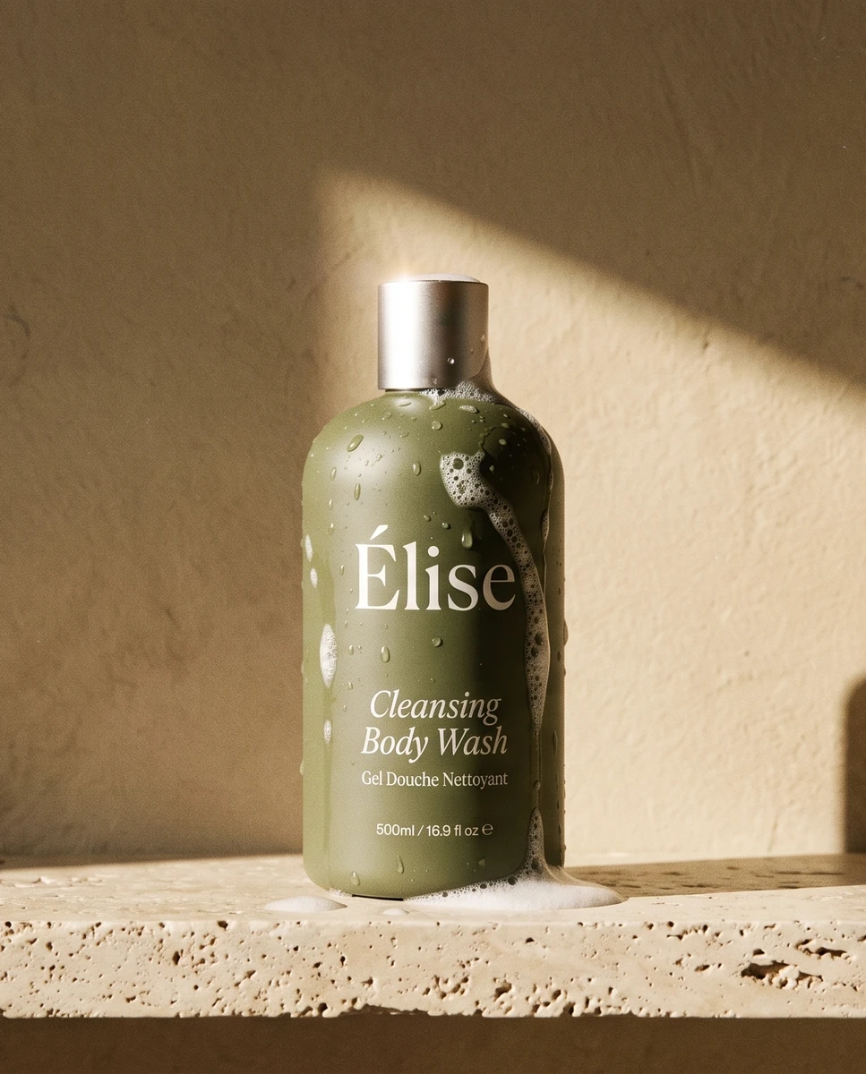 One Elise cleansing body-wash bottle grounded on a sunlit stone shelf